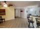 Open-concept living room with bar seating and tile floors, creating a seamless flow for modern living at 16402 N 31St St # 134, Phoenix, AZ 85032
