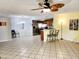 Bright living room with tile floors, ceiling fan, and breakfast bar to the kitchen at 16402 N 31St St # 134, Phoenix, AZ 85032