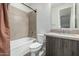 Bathroom featuring a tub, vanity with wood cabinets, and tiled walls at 1717 E Morten Ave # 16, Phoenix, AZ 85020