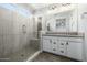 Bright bathroom with a tiled walk-in shower, double sink vanity, and contemporary finishes at 1717 E Morten Ave # 16, Phoenix, AZ 85020
