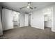 A large bedroom with a ceiling fan, barn door to the bathroom, and entrance to the closet at 1717 E Morten Ave # 16, Phoenix, AZ 85020