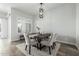 Bright dining room features a dark wood table, upholstered chairs, and a modern chandelier at 1717 E Morten Ave # 16, Phoenix, AZ 85020