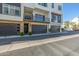 Contemporary townhome featuring stone accents, dark garage doors, and a private balcony with iron railings at 1717 E Morten Ave # 16, Phoenix, AZ 85020