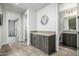 Hallway with a bathroom and another room in view and cabinets at 1717 E Morten Ave # 16, Phoenix, AZ 85020