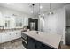 Modern kitchen with stainless steel appliances, white cabinets, and a large center island at 1717 E Morten Ave # 16, Phoenix, AZ 85020