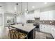 Open kitchen and dining area with pendant lighting, island seating, and stylish backsplash at 1717 E Morten Ave # 16, Phoenix, AZ 85020
