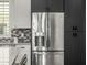 Close up of the refrigerator with stainless steel finish and dark wood cabinetry at 1717 E Morten Ave # 16, Phoenix, AZ 85020
