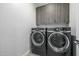 Laundry room with gray cabinets and front loading washer and dryer at 1717 E Morten Ave # 16, Phoenix, AZ 85020