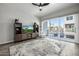 Bright living room featuring a flat-screen TV, modern decor, and a sliding glass door to the balcony at 1717 E Morten Ave # 16, Phoenix, AZ 85020