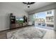 Bright living room featuring a flat-screen TV, modern decor, and a sliding glass door to the balcony at 1717 E Morten Ave # 16, Phoenix, AZ 85020