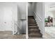 Carpeted staircase with white railings, leading to the upper levels of the home with access to the basement at 1717 E Morten Ave # 16, Phoenix, AZ 85020