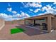 Expansive backyard with a covered patio, perfect for outdoor entertaining and relaxing at 17310 W Seldon Ln, Waddell, AZ 85355