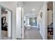 Hallway view of a bathroom with walk in shower, stand alone tub, and grey wood flooring at 17310 W Seldon Ln, Waddell, AZ 85355