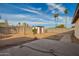 Large backyard with a shed, featuring desert landscaping and ambient string lights at 17420 N 36Th Ave, Glendale, AZ 85308