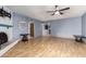 Spacious living room with a white painted brick fireplace and wood floors at 17420 N 36Th Ave, Glendale, AZ 85308