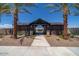 Clubhouse entrance with two palm trees nearby at 17573 W Georgia Ave, Litchfield Park, AZ 85340