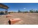Recreational park featuring cornhole, picnic tables, and shaded seating areas at 17605 W Georgia Ave, Litchfield Park, AZ 85340