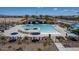 Aerial view of a community pool with lounge chairs, umbrellas, and a picnic area at 17605 W Georgia Ave, Litchfield Park, AZ 85340