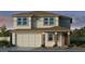 A traditionally styled two-story home featuring a two-car garage and stone accents at 17605 W Georgia Ave, Litchfield Park, AZ 85340