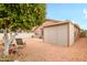 Landscaped backyard showcasing a vibrant citrus tree and an enclosed patio, perfect for outdoor living at 18080 W Udall Dr, Surprise, AZ 85374
