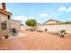 Expansive backyard showcasing vibrant landscaping, a charming patio area, and comfortable seating arrangements at 18080 W Udall Dr, Surprise, AZ 85374