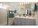 Bathroom featuring double sinks, vanity and a glass-enclosed shower at 18080 W Udall Dr, Surprise, AZ 85374