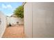 Enclosed patio area next to a well kept backyard with thriving citrus tree and decorative garden accents at 18080 W Udall Dr, Surprise, AZ 85374