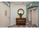 Bright entryway featuring wood-look floors, archway, decorator mirror, and adjacent closet at 18080 W Udall Dr, Surprise, AZ 85374