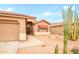 Single-Gathering home with xeriscaped front yard, desert landscaping, two-car garage, and brown exterior paint at 18080 W Udall Dr, Surprise, AZ 85374