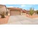 Charming single-Gathering home with desert landscaping, two-car garage, attractive paint, and sidewalk at 18080 W Udall Dr, Surprise, AZ 85374