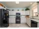 Well-equipped kitchen with black appliances, ample counter space and storage at 18080 W Udall Dr, Surprise, AZ 85374