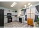 Bright kitchen featuring modern appliances and ample cabinet space and neutral tones at 18080 W Udall Dr, Surprise, AZ 85374