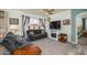 Comfortable living room with a ceiling fan, decorative fireplace and neutral tones at 18080 W Udall Dr, Surprise, AZ 85374