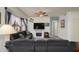 Comfortable living room featuring wood-look floors, modern lighting, neutral paint, and decorator fireplace at 18080 W Udall Dr, Surprise, AZ 85374