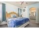 Relaxing main bedroom with a ceiling fan and an archway leading to bathroom at 18080 W Udall Dr, Surprise, AZ 85374