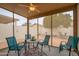 Inviting sunroom featuring comfortable seating and views of the beautifully landscaped backyard with citrus tree at 18080 W Udall Dr, Surprise, AZ 85374