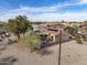 Aerial view of a desert home with red tile roof, solar panels, and a walled backyard with a covered patio at 18400 N Deer Grass Ct, Surprise, AZ 85374