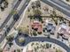 Aerial view of home with a tile roof, desert landscaping, pool, and nearby street at 18400 N Deer Grass Ct, Surprise, AZ 85374