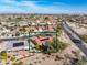 Wide aerial shot displaying a home, including a red tile roof, solar panels and surrounding neighborhood at 18400 N Deer Grass Ct, Surprise, AZ 85374