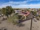 An elevated aerial view of a single-Gathering desert home with solar panels and covered patio in a planned community at 18400 N Deer Grass Ct, Surprise, AZ 85374