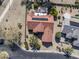 Aerial view of tile roofed home with solar panels, pool, and lush desert landscaping at 18400 N Deer Grass Ct, Surprise, AZ 85374