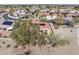 The aerial shot features a desert home with solar panels and red tile roof, a covered patio, and desert landscaping at 18400 N Deer Grass Ct, Surprise, AZ 85374