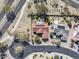 Aerial view of a home with a swimming pool, desert landscaping, palm trees, and neighborhood street at 18400 N Deer Grass Ct, Surprise, AZ 85374