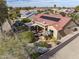 Inviting backyard patio area featuring an umbrella-covered table and a comfortable seating area with a covered pergola at 18400 N Deer Grass Ct, Surprise, AZ 85374