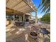 Entertaining backyard featuring a shaded patio, pond, tiled patio and desert landscaping at 18400 N Deer Grass Ct, Surprise, AZ 85374