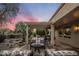 Outdoor covered patio area with comfortable seating and decorative outdoor elements at 18400 N Deer Grass Ct, Surprise, AZ 85374