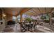 Backyard patio with dining set, grill, lush desert landscaping and waterfall at 18400 N Deer Grass Ct, Surprise, AZ 85374