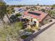 Inviting backyard patio area featuring an umbrella-covered table and a comfortable seating area with a covered pergola at 18400 N Deer Grass Ct, Surprise, AZ 85374