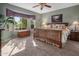 Comfortable bedroom with a large window and wooden bedframe complemented by neutral tones at 18400 N Deer Grass Ct, Surprise, AZ 85374