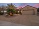 Home featuring desert landscaping, gravel, palm tree, and a two car garage at 18400 N Deer Grass Ct, Surprise, AZ 85374